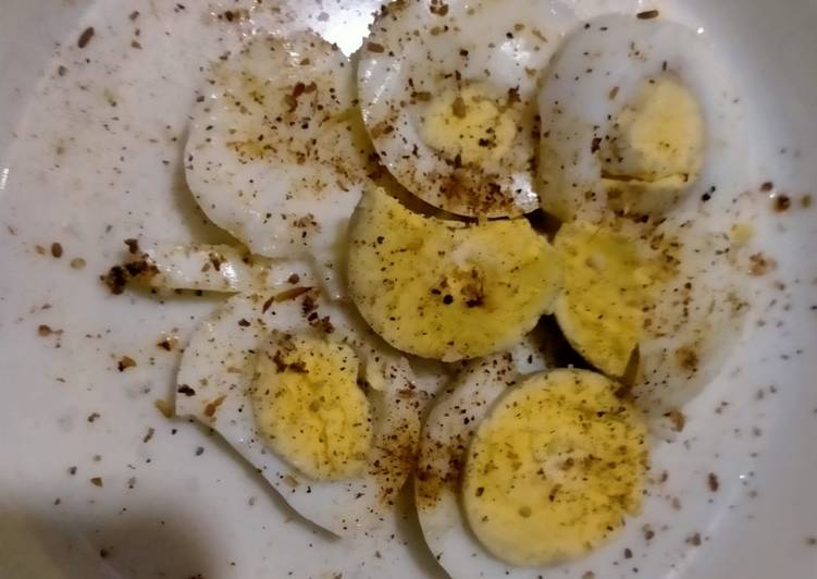 Boiled egg with salt and pepper
