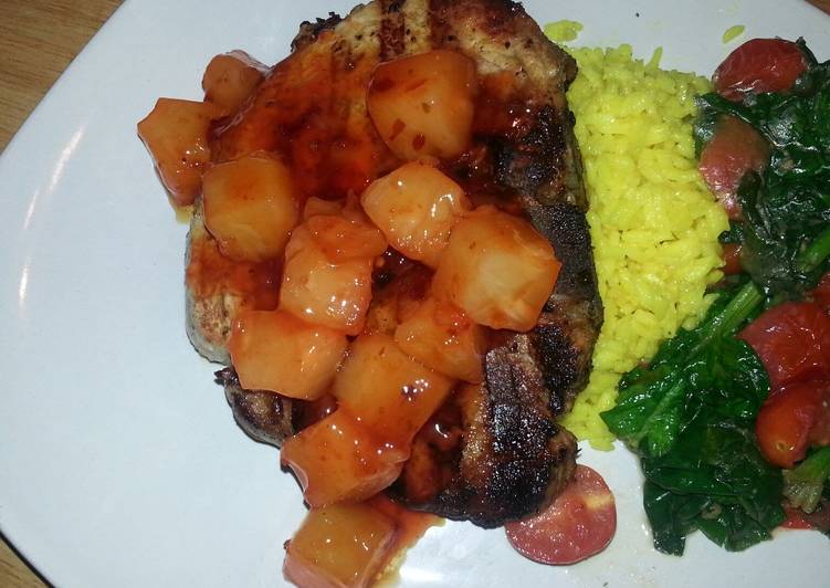 Grilled center cut pork chop with sweet&sour pineapples, saffron rice and garlic spinach tomato saut