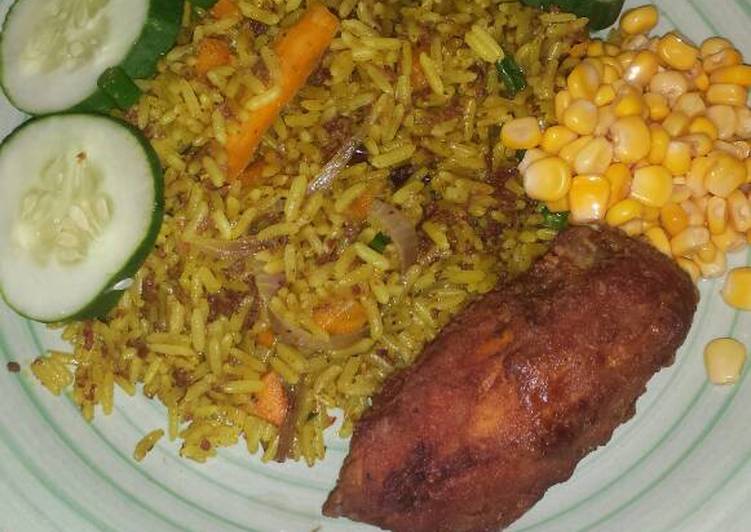 Fried rice garnished with sweet corn, cucumber and fried chicken
