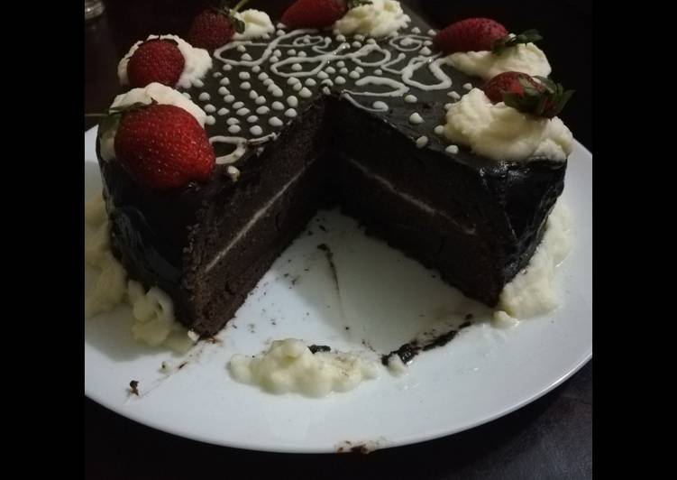 Chocolate cake with chocolate ganache and whipped cream icing